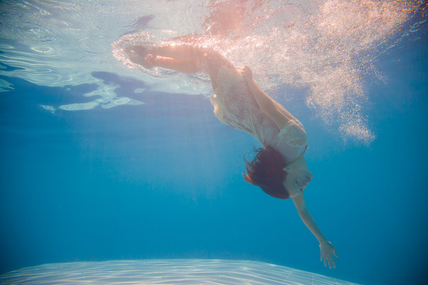 Young woman swimming undewater - Zdjęcie, obraz