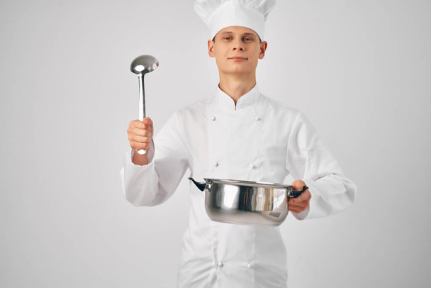 человек в форме шеф-повара с кастрюлей в руках, готовящий профессиональные рестораны - Фото, изображение