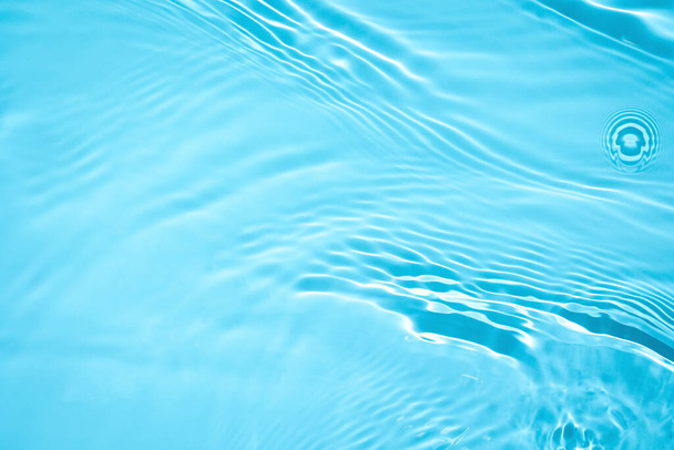 διάφανη μπλε χρωματισμένη καθαρή υφή επιφάνειας ήρεμου νερού  - Φωτογραφία, εικόνα