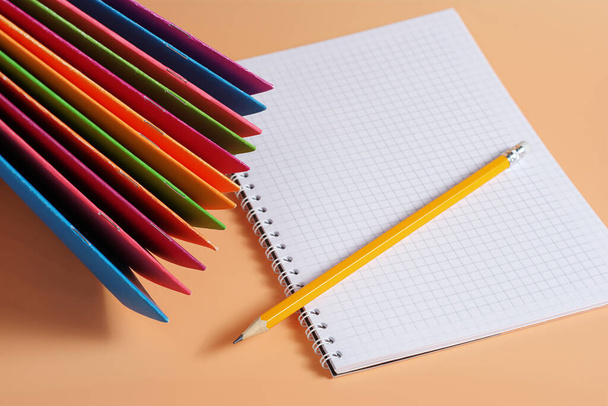 School notebooks and pencil on beige background - Photo, Image