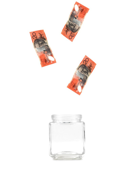 Australian twenty dollar notes floating into a jar isolated against a white background - Photo, Image