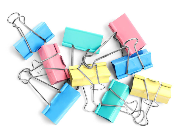 Colorful binder clips on white background, top view. Stationery item - Zdjęcie, obraz