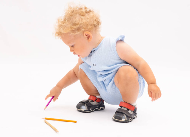 Little girl draws with a pencil on white background - 写真・画像