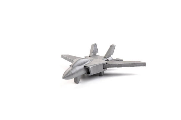 Beyaz arkaplanda 3 boyutlu bir yazıcıda üretilen gri model bir savaş uçağı. ulaşım kavramı - Fotoğraf, Görsel