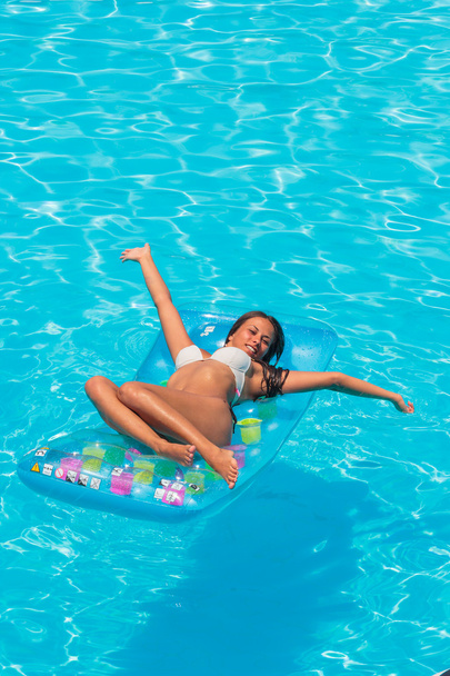 A girl is relaxing in a swimming pool - Foto, Imagem