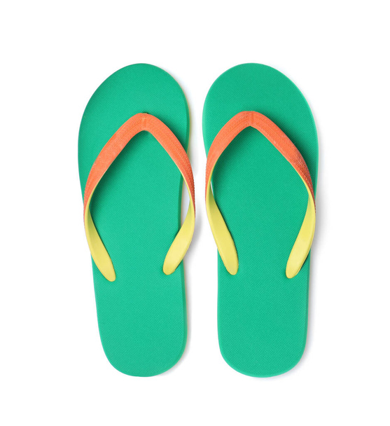Pair of stylish bright flip flops isolated on white, top view - 写真・画像