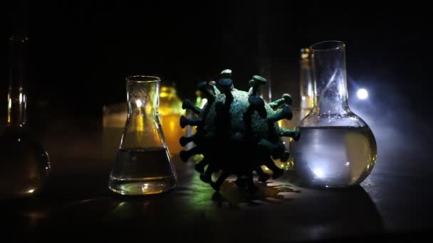 Corona virus Vaccine concept with syringe and green Corona virus novel miniature. Vaccine Concept of fight against coronavirus. Creative decoration with fog and backlight. Selective focus - Footage, Video