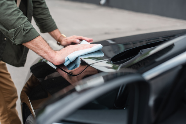 Cropped view of man waxing car outdoors  - Photo, Image