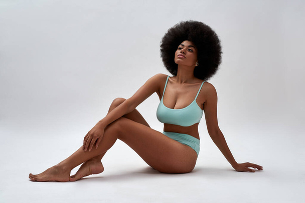 Seductive young african american girl in blue lingerie - 写真・画像