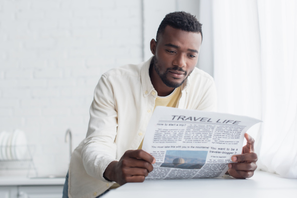 african american man in shirt reading travel life newspaper  - Fotografie, Obrázek