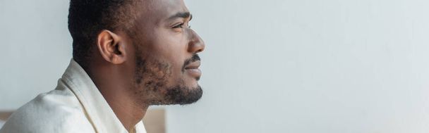 side view of pensive young african american man looking away, banner - 写真・画像
