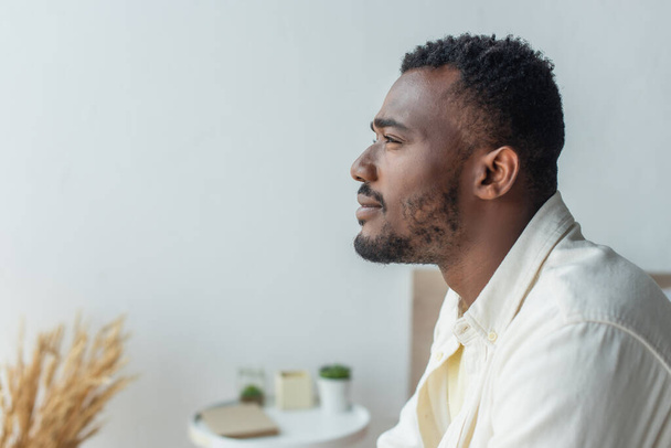 side view of pensive young african american man looking away - 写真・画像