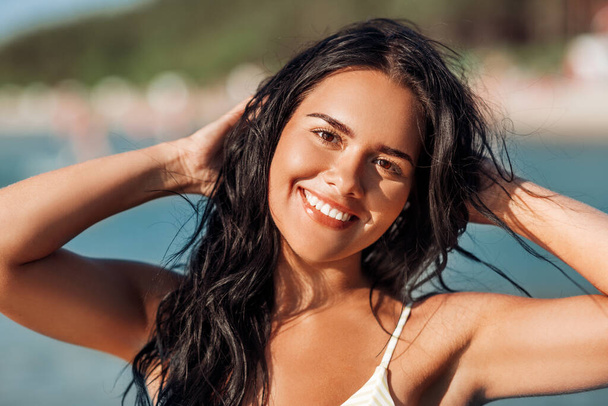 smiling young woman in bikini swimsuit on beach - Zdjęcie, obraz