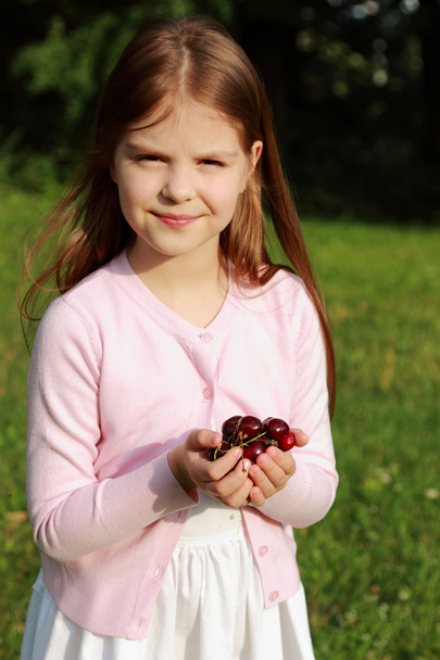 Lovely little girl with cherries - Photo, image