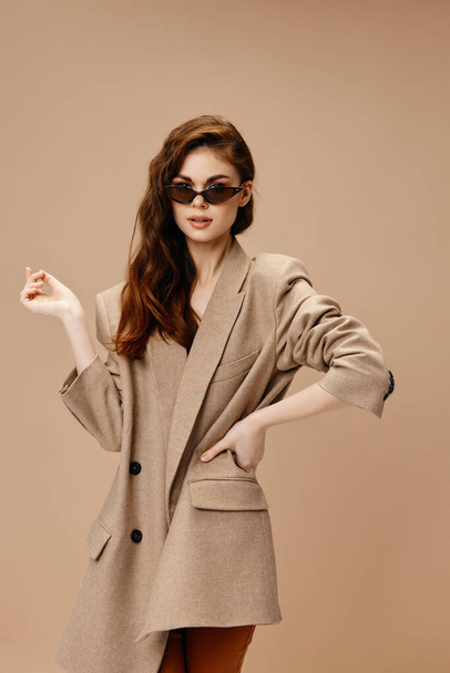 romantic woman in a coat on a beige background posing  - Foto, immagini