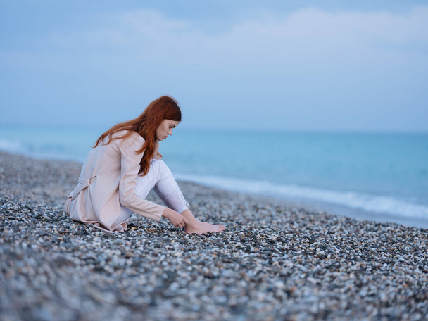 woman sitting on the shore on  fresh air. High quality photo - Zdjęcie, obraz