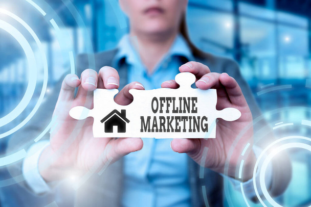 Text sign showing Offline Marketing. Business showcase Advertising strategy published outside of the internet Business Woman Holding Jigsaw Puzzle Piece Unlocking New Futuristic Tech. - Zdjęcie, obraz
