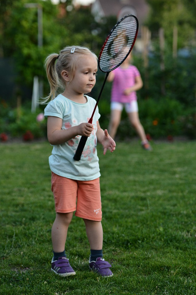 schattig klein meisje spelen badminton - Foto, afbeelding