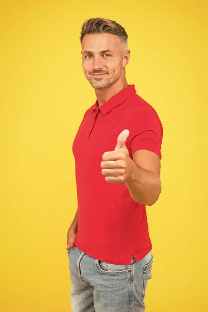 Be your best. Happy guy give thumbs up yellow background. Approval gesture. Hand sign. Casual fashion. Trendy style. Stylish menswear. Mens wear. It deserves thumbs up - Photo, Image