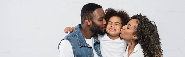 happy african american couple kissing daughter on grey, banner - Фото, изображение