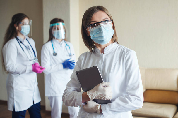 Team of doctor and nurse in hospital. Healthcare and medicine concept. Medical staff wearing face shield and medical mask. Group of doctors ready to fight coronavirus. Hospital staff during coronavirus quarantine. - Fotó, kép