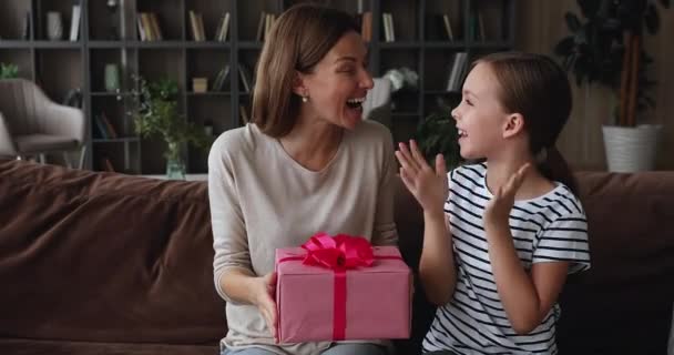 Caring small kid making present to joyful mother. - Filmati, video