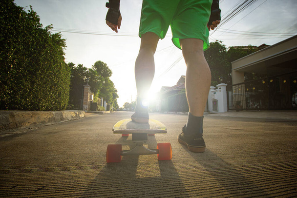 Surfskate player play skateboard exercise in the outdoor.Asian lifestyle for plays extream sports.Freestyle dynamic action skateboarding in the street. - 写真・画像