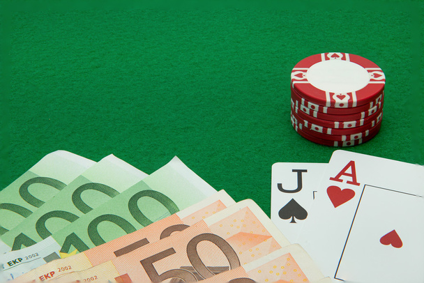 Blackjack hand with Euro notes and chips on green background - Foto, Imagem