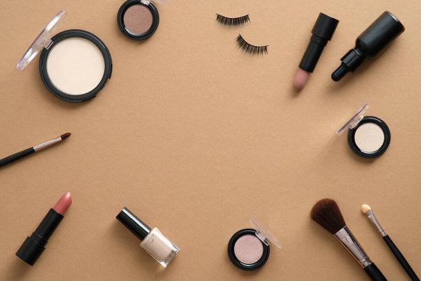 Fashion makeup cosmetic accessories on brown background. Flat lay, top view, copy space. - Photo, Image