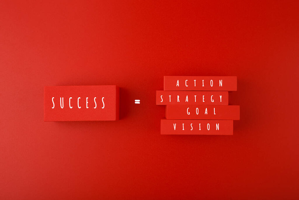 Trendy minimal success formula or business development concept in red colors. Vision, goal, strategy, action written on blocks against red background.  - Photo, image