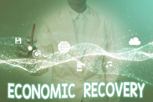 Text sign showing Economic Recovery. Conceptual photo rise of business activity signaling the end of a recession Lady In Uniform Holding Tablet In Hand Virtually Tapping Futuristic Tech. - Foto, afbeelding
