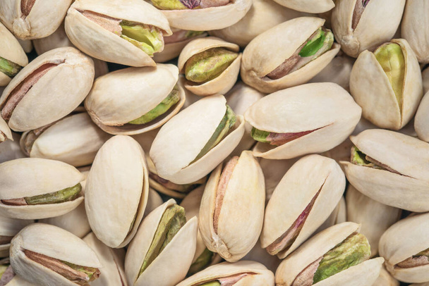 Pistachios texture. Pistachios background. Tasty pistachios close up. Top view - Photo, image
