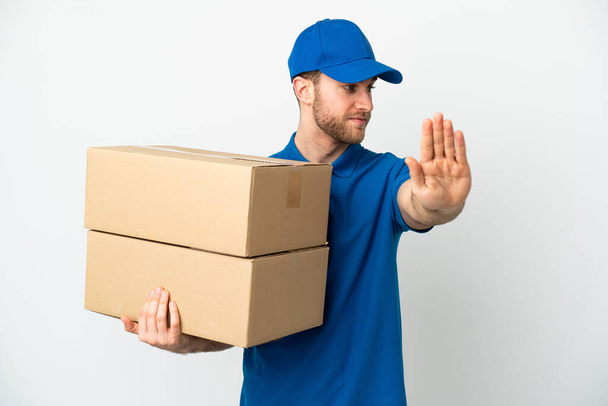 Delivery man over isolated white background making stop gesture and disappointed - Фото, зображення