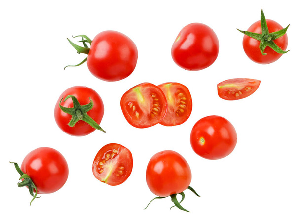 Cherry tomatoes and halves are flying close-up on a white background. Isolated - Fotoğraf, Görsel