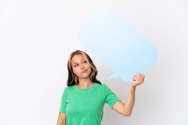 Teenager Russian girl isolated on blue background holding an empty speech bubble - Photo, Image