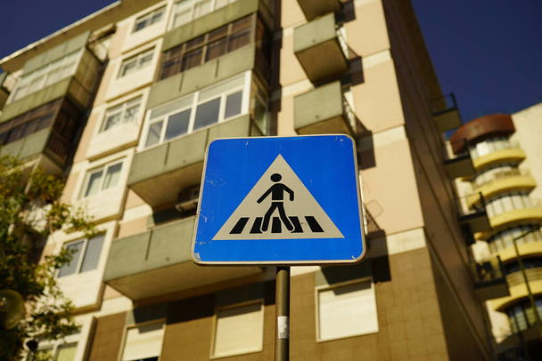A pedestrian crossing road sign in the urban residential area - Zdjęcie, obraz