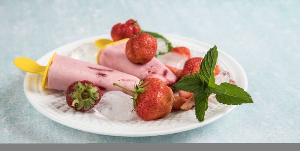Close-up of homemade vegan ice cream on coconut milk with strawberries. - Photo, image