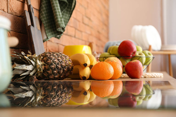 Fresh fruits on table in kitchen - Zdjęcie, obraz
