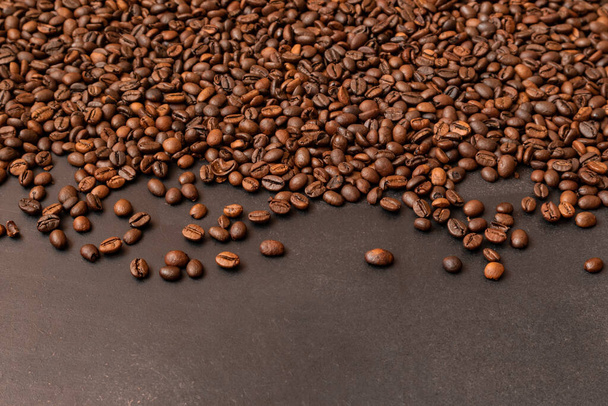 Fresh roasted coffee beans on dark background. Selective focus. - Photo, Image