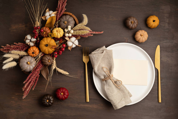 Rustic menu mockup with plate and autumn table decoration. Floral interior decor for fall holidays with handmade pumpkins. Holiday dinner concept. Flatlay, top view - Photo, Image