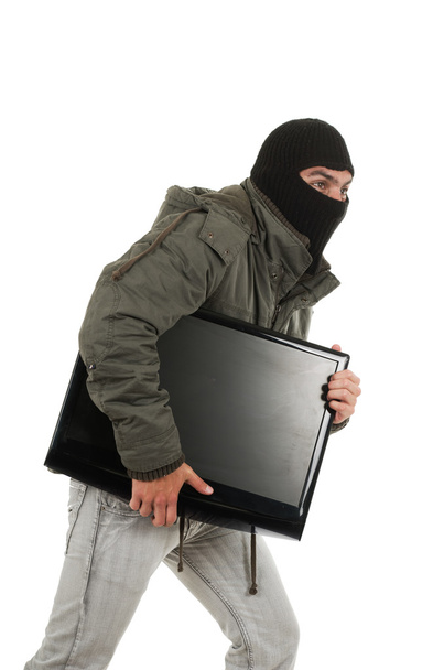 young thief wearing black hood and jacket - Fotó, kép