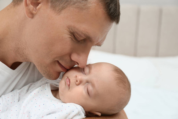 Father holding his cute sleeping baby at home, closeup - Foto, Imagem