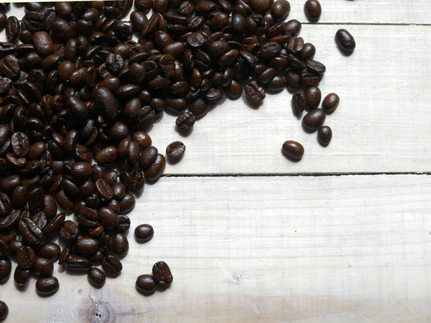 Coffee beans on wooden background flat lay shot with copy space - Fotó, kép