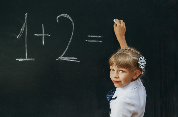 Happy school girl on math classes finding solution and solving problems - Foto, Imagen