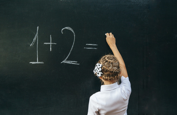 Happy school girl on math classes finding solution and solving problems - Fotoğraf, Görsel