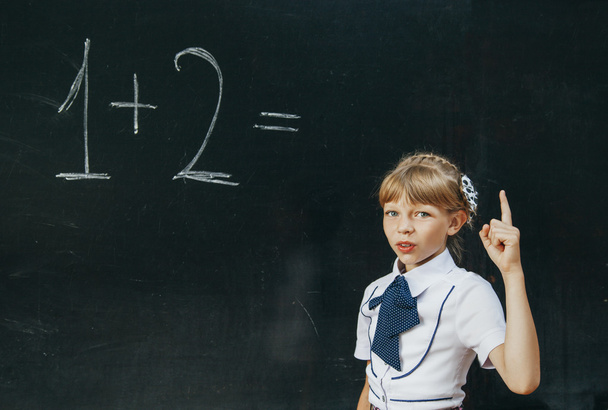 Happy school girl on math classes finding solution and solving problems - Foto, Imagem