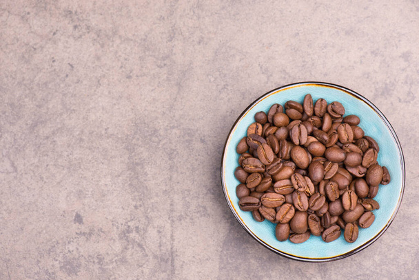 Roasted coffee beans on a brown textured background, empty space for text, hot drinks ingredients - 写真・画像