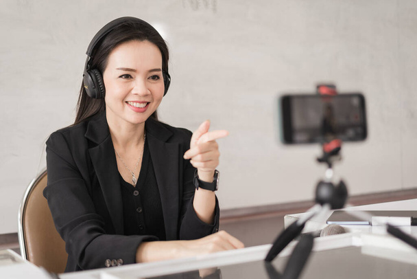 Stock photo of a Southeast Asian Ethnic business woman student teacher tutor video conference calling on laptop computer talk by webcam learn teach in online chat, distance webinar online teaching concept - Photo, Image