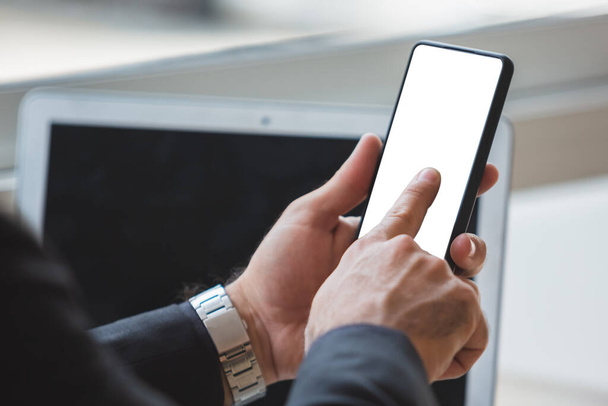 Close-up male hands finger touch screen display smartphone with blank white screen in cafe. chatting connection communication online. smartphone mockup. - 写真・画像