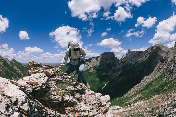 Successful woman backpacker hiking on alpine mountain top - Fotografie, Obrázek